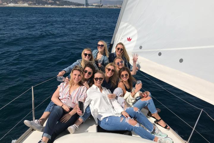 a group of people sitting in a boat on a body of water